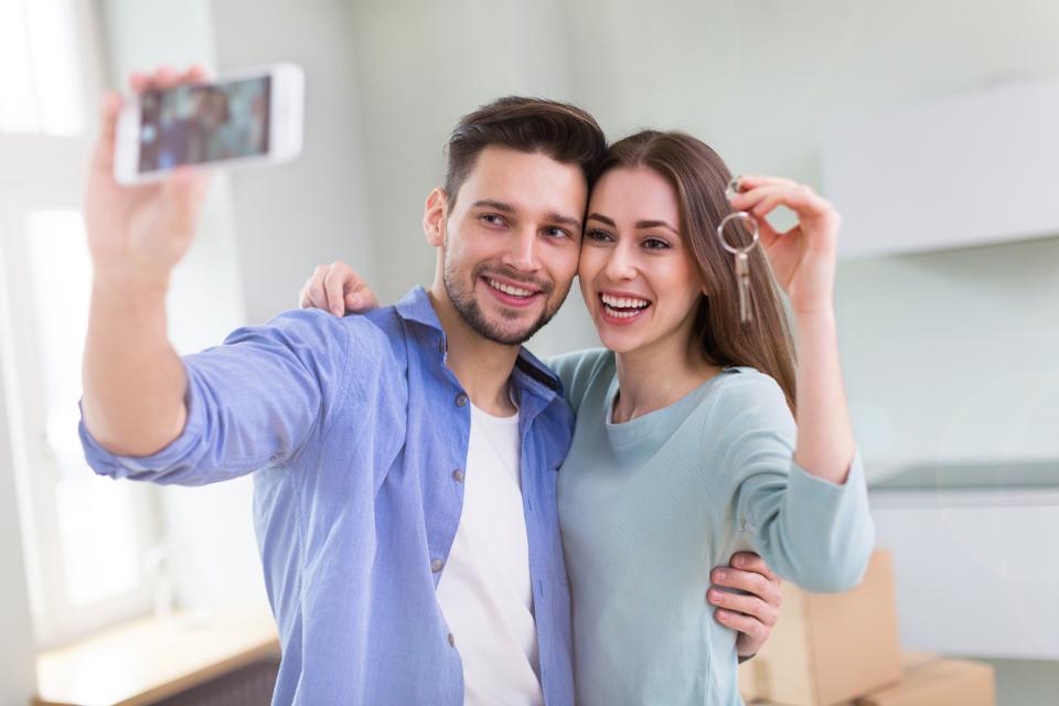 A happy young couple taking a selfie.